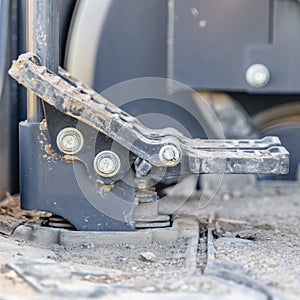 Square Foot controls and floor of a construction machinery covered in dirt