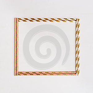 Square Frame from bright multicolor paper drinking straws with Gold striped on light background