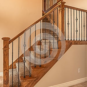 Square frame Carpeted stairs with wood handrail and metal railing inside an empty new home