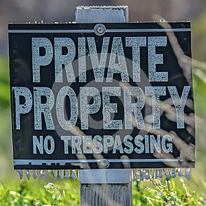 Square frame Close up of a Private Property No Trespassing sign on a sunny day