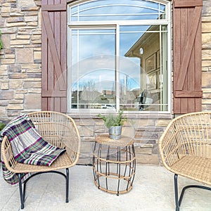 Square frame Comfortable wicker chairs on a veranda day light