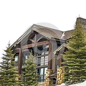 Square frame Exterior of a beautiful wooden house amid fresh snow on a cloudy winter day