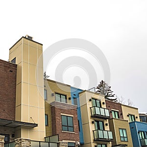 Square frame Front of townhomes with balconies against cloudy winter sky in Park City Utah