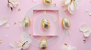 a square frame with gold foiled eggs and some decorative petals