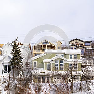 Square frame Homes on snowy residential mountain slope in scenic Park City Utah in winter