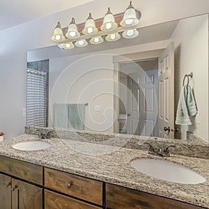 Square frame Interior of a bathroom with vanity sink with lights and mirror