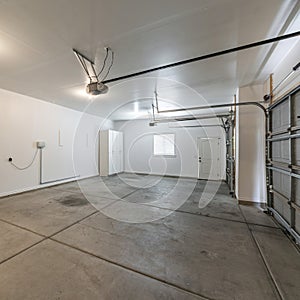 Square frame Interior of a garage with double automatic doors and concrete floor