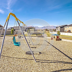 Square A-frame kids swings in an urban playground