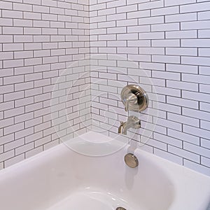 Square frame Modern tiled white bathtub with shower bright interior