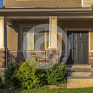 Square frame Stairs leading to porch and front door with sidelight at the entrance of home