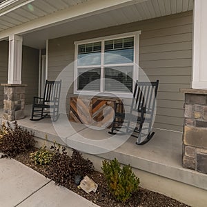 Square frame Two rocking chairs at the front entrance to a home