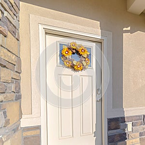 Square Front door of modern home with sunflower wreath