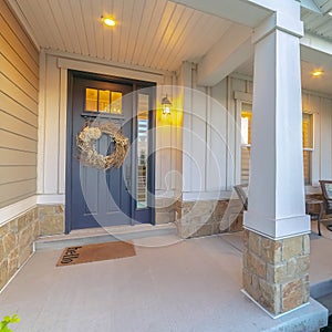 Square Front and sidelight of home with front porch and wood siding exetrior wall