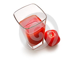 Square glass with juice and suare tomato