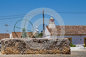 Square with a green water pump, Portugal