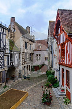 Square with half-timbered houses, in the medieval village Noyers-sur-Serein photo