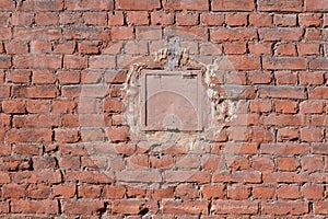 Square hatch in a old brick wall