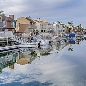 Square Huntington Beach California scenery with homes overlooking the road and canal