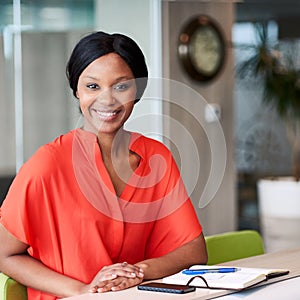 Square image of businesswoman looking at camera in business lounge