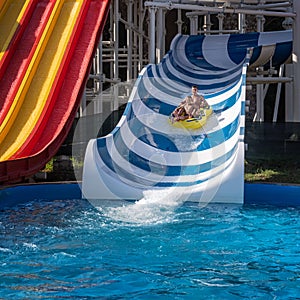 Square image of happy family at the water slide