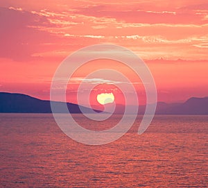 Red sunset over the sea with sun in the centre, square