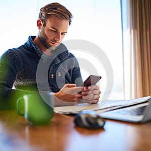 Square image of young man texting on his mobile phone