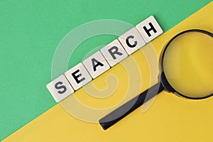 Square letters with text SEARCH over yellow and green background