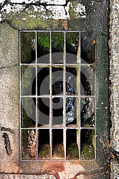 square manhole with moss and dirt