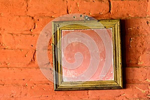 Square mirror on a brick wall