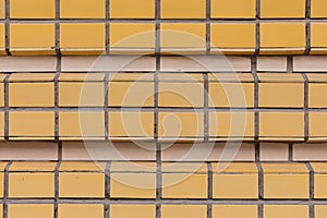 Square Orange and beige ceramic tile pasted in row on wall horizontal photo background