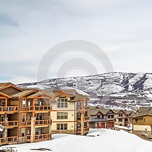Square Panoramic view of homes with balconies and surrounded with snow in winter