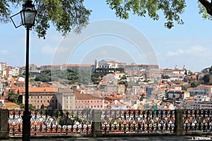 Square with panoramic view on Lisbon, Portugal - architecture, hills, green trees photo