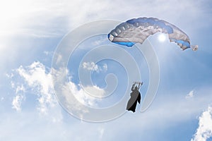 Square parachute canopy in blue sky photo