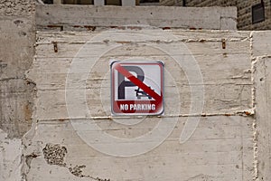 a square parking sign is prohibited on a concrete wall. Tools for regulating traffic and parking regulations
