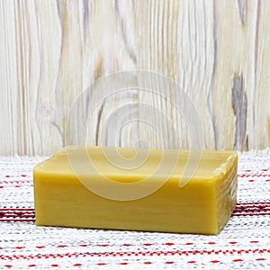 A square photo of natural handmade organic olive oil soap on the wooden table. Rustic background. Bath spa accessories. Table doil