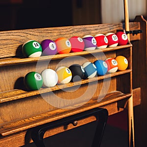 Square photo Set of balls for a game of pool billiards on shelve