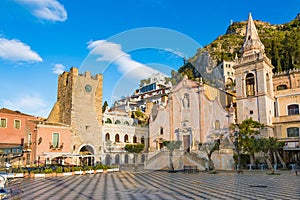 Square Piazza IX Aprile with San Giuseppe church and Clock Tower in Taormina, Sicily, Italy