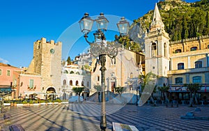 Square Piazza IX Aprile with San Giuseppe church and Clock Tower in Taormina, Sicily, Italy