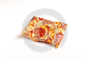 Square piece of Pepperoni Pizza on white table.