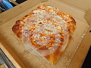 A square pizza wedge sliced on display ready for serving