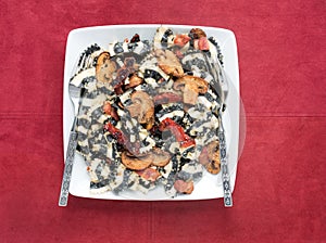 Black and White Bow Tie Pasta with Tomatoes and Mushrooms on Rust Suede