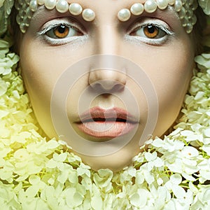 Square portrait of lovely young woman with tender makeup and flo