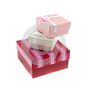 Square red and pink striped giftbox with gray and cream mini polar on an isolated background