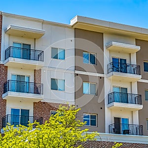 Square Residential building featuring red brick exterior wall and small balconies