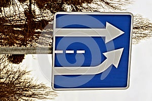Square road sign with arrows on the street