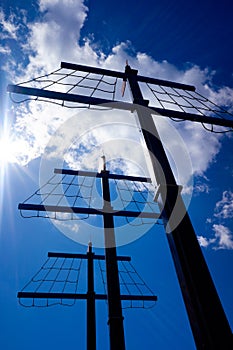 Square sail mainmast against the sun in a children`s game