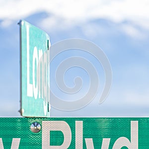 Square Selective focus on a green and white road street sign that reads Blvd