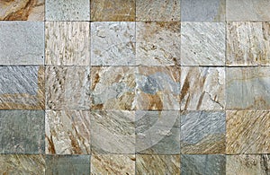 Square shape slate and quartzite tiles. Multicolored wall, main colorsare gray, brown and white