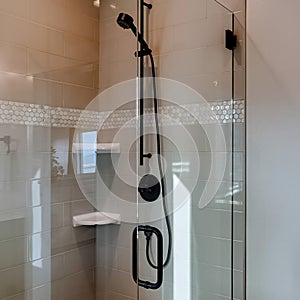 Square Shower stall with frameless glass enclosure and hinged door inside bathroom