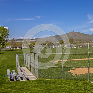 Square Softball or Baseball field with view of mountain and sky on a sunny day
